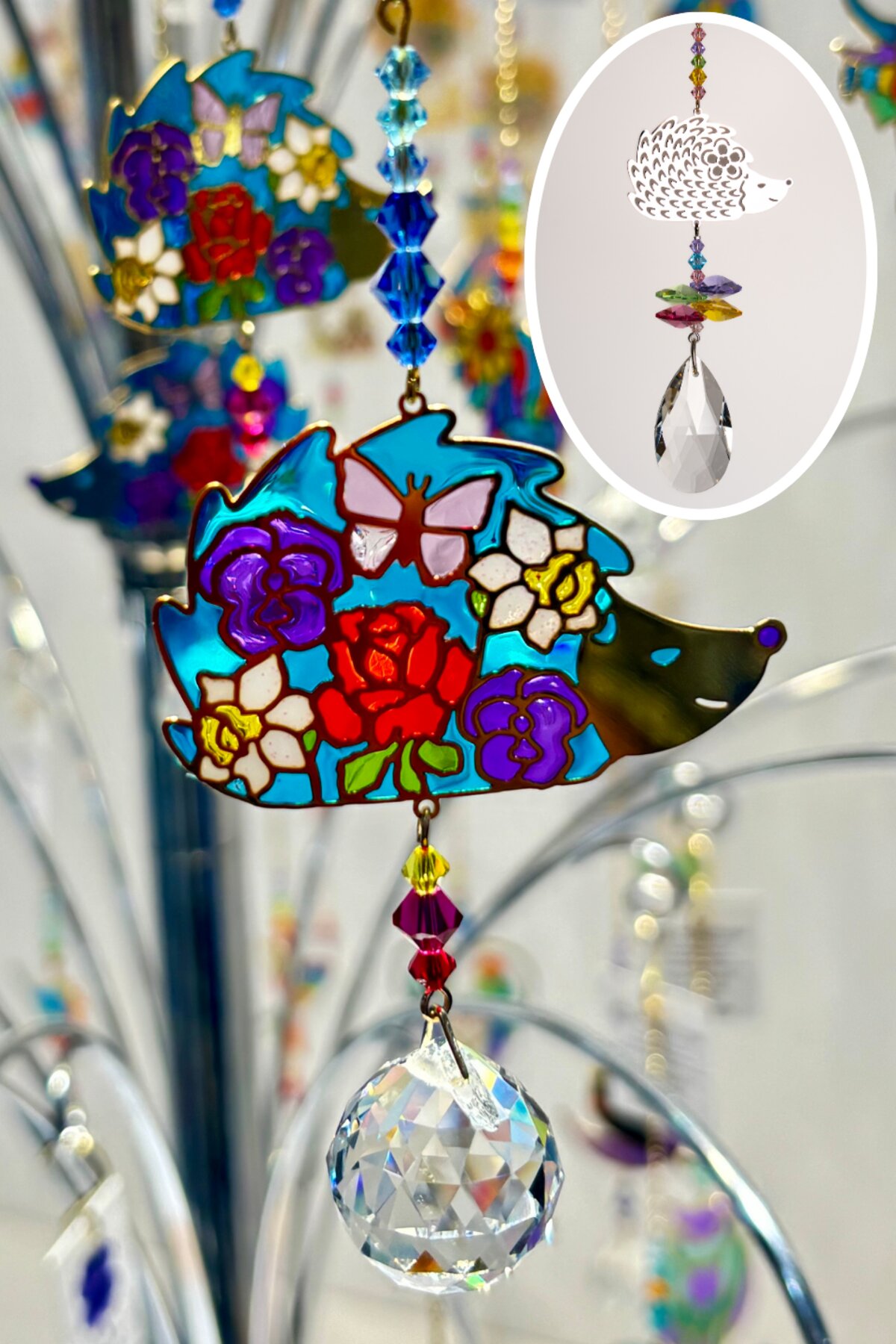 The stained-glass-effect Crystal Dreams hedgehog suncatcher, with the Crystal Fantasies hedgehog design inset for comparison